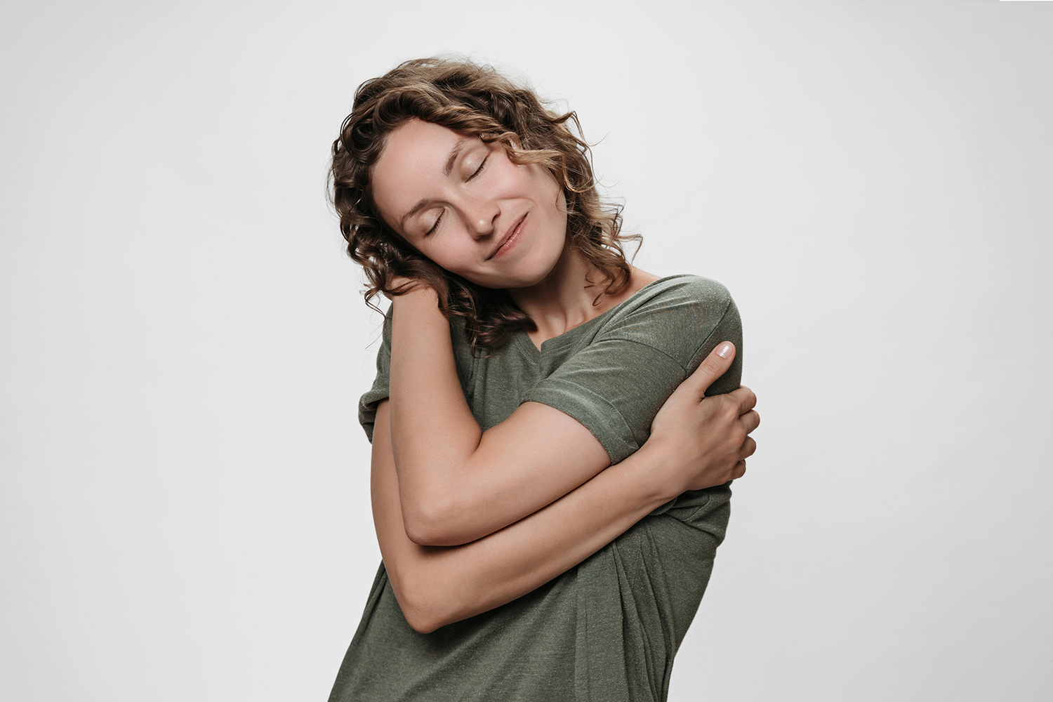 a woman hugging herself warmly