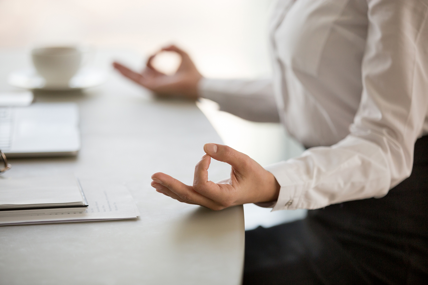 Exploring Two Paths of Paying Attention a businesswoman meditating at her desk