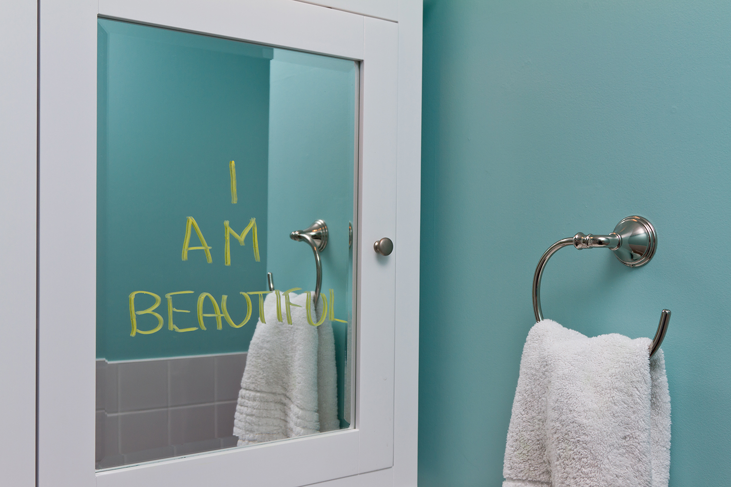 How I Went from Hating My Body to Being Okay with It A bathroom mirror with "I am beautiful" written on it.