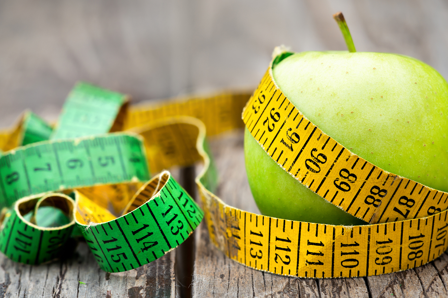 The Skinny on Why We Get Fat an apple with a measuring tape wrapped around it
