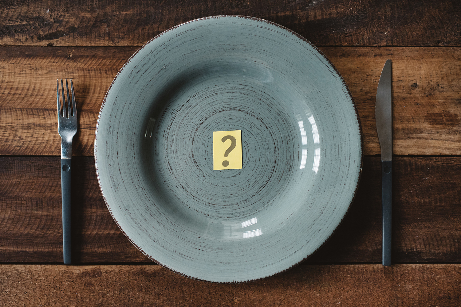 The Blood Type Diet Top view of a table set with cutlery with question mark in a plate.