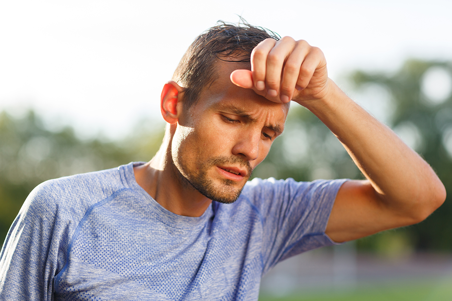 A fit man experiencing fatigue during his workout