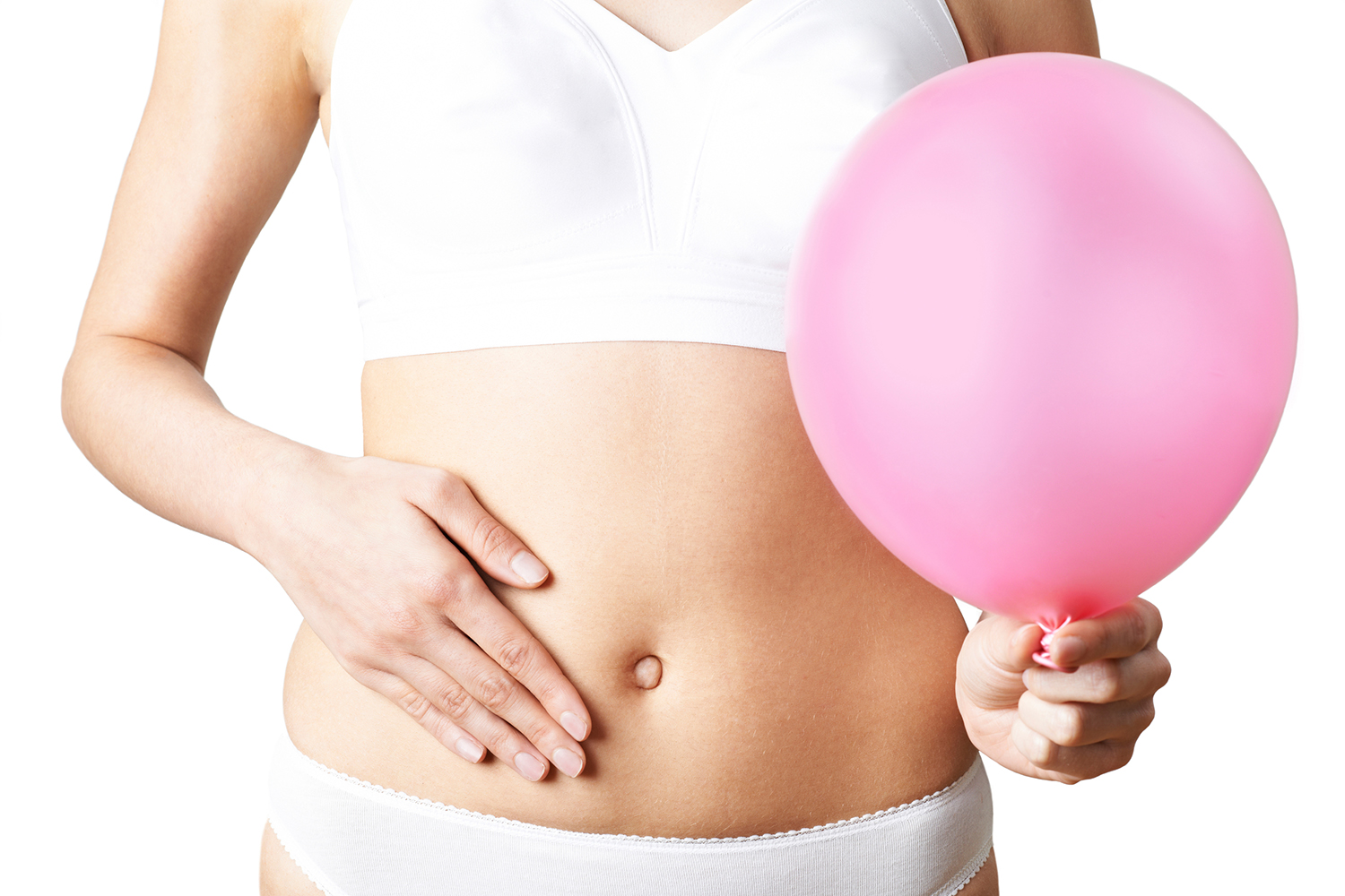 Natural Remedies for Bloat-Free Digestion a woman feeling bloated, holding a balloon as a metaphor
