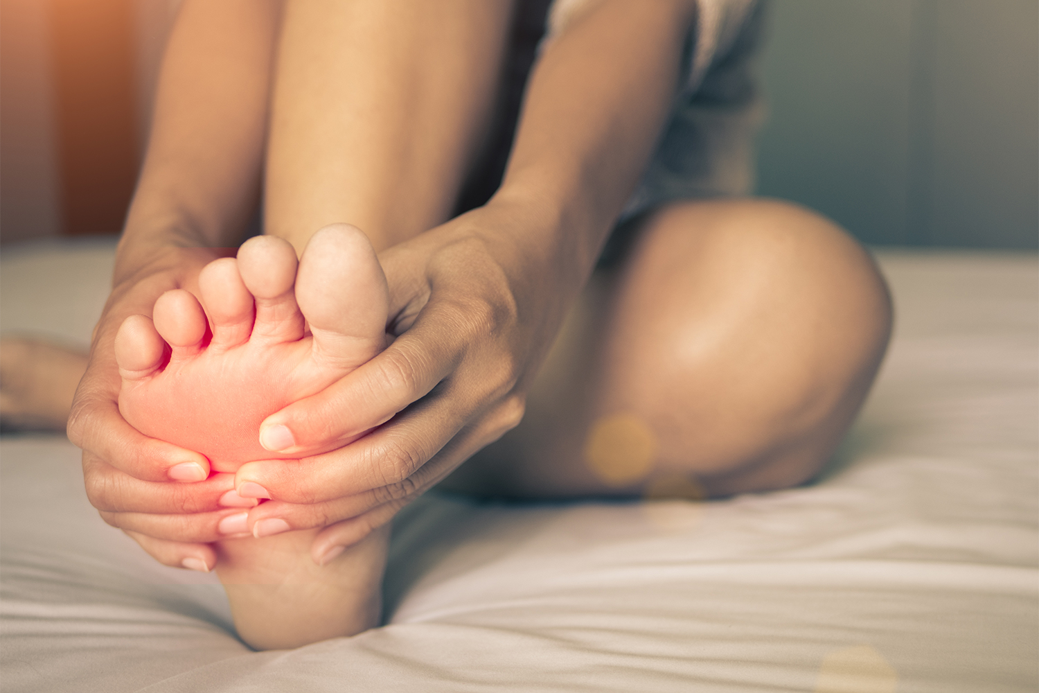 A woman massaging pain in his foot