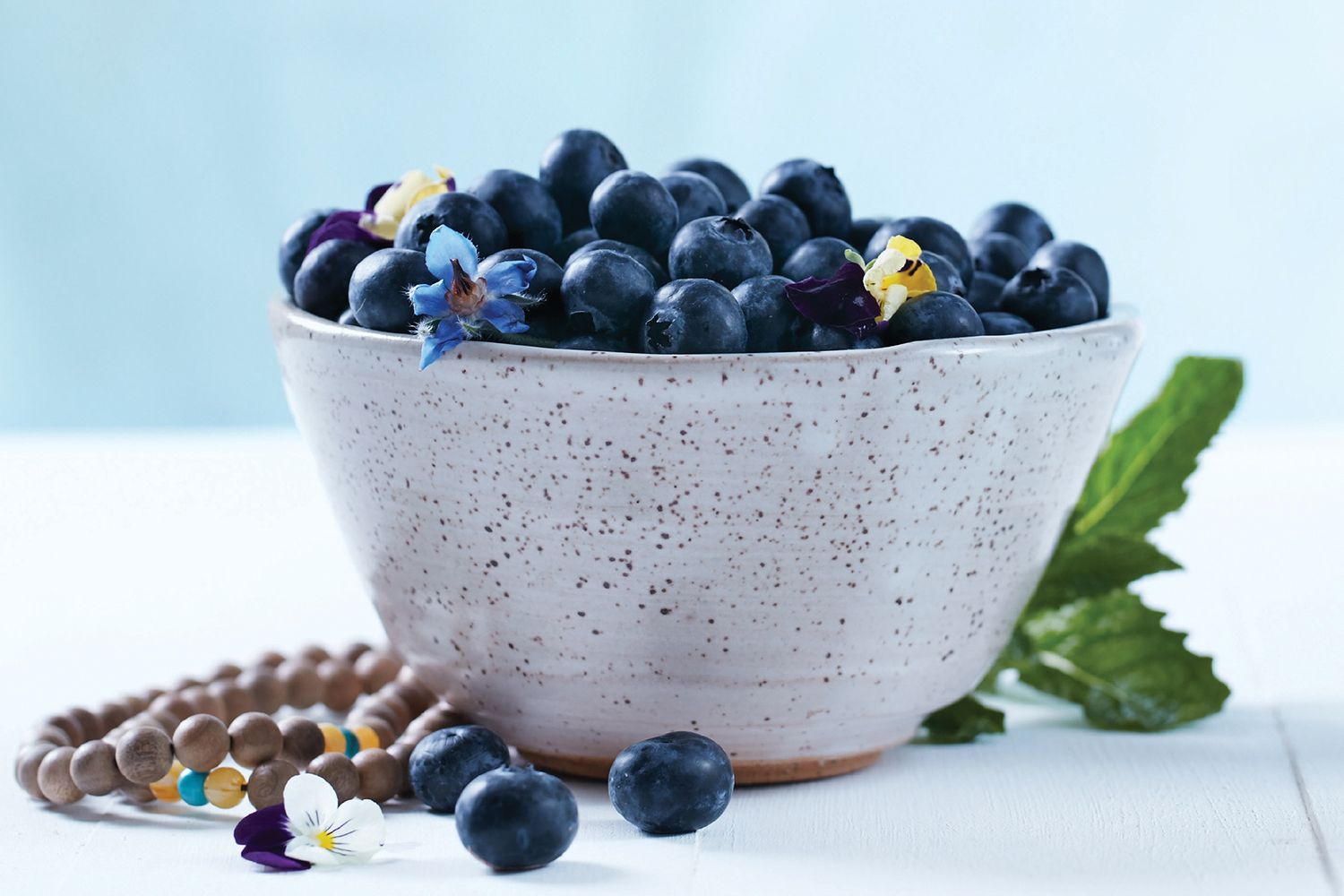Spring Cleaning: Five Questions You Need to Ask Your Body A bowl of blueberries and some Buddhist prayer beads