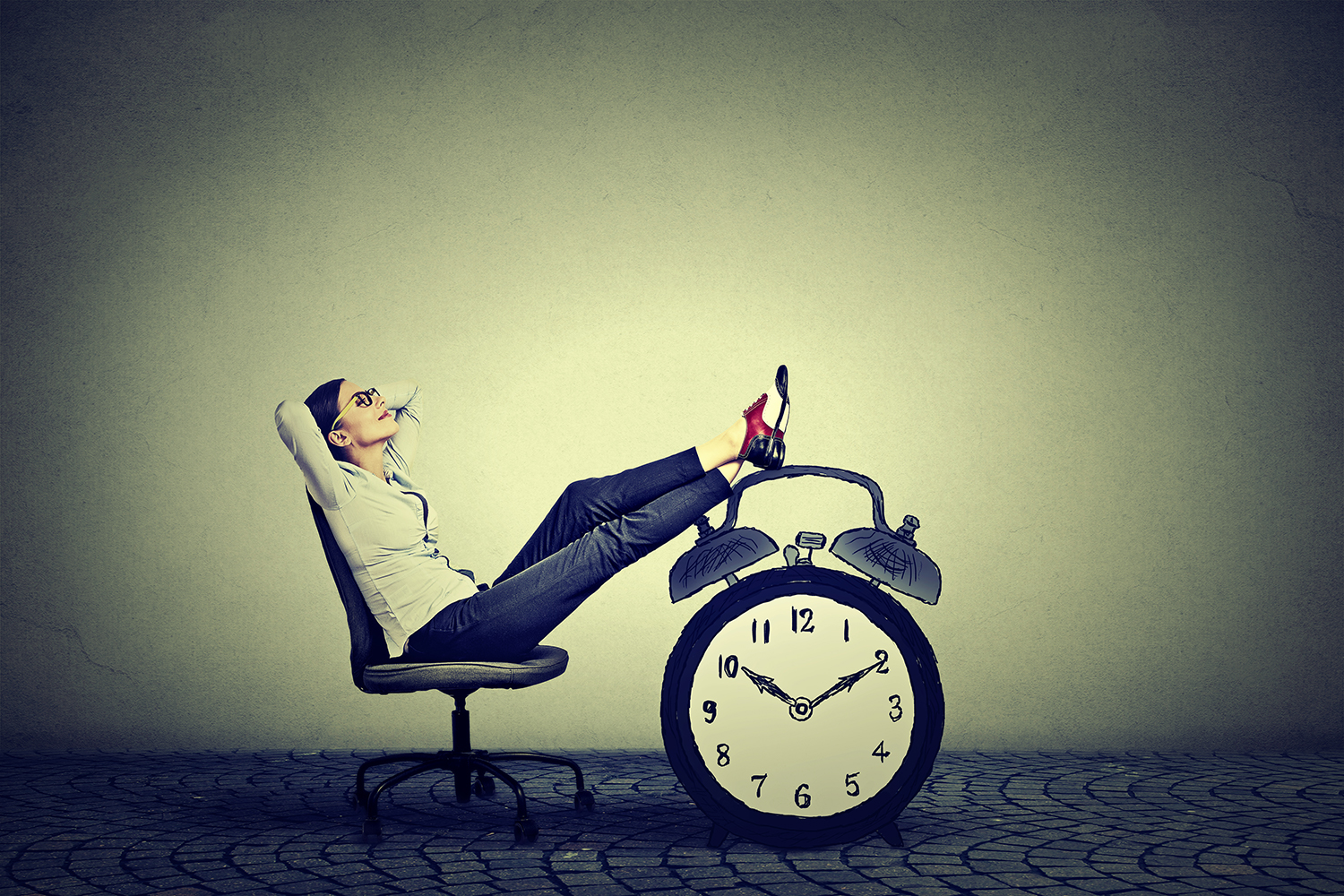 Time Management: The Compass vs The Clock Woman relaxing on a chair with feet resting on a clock