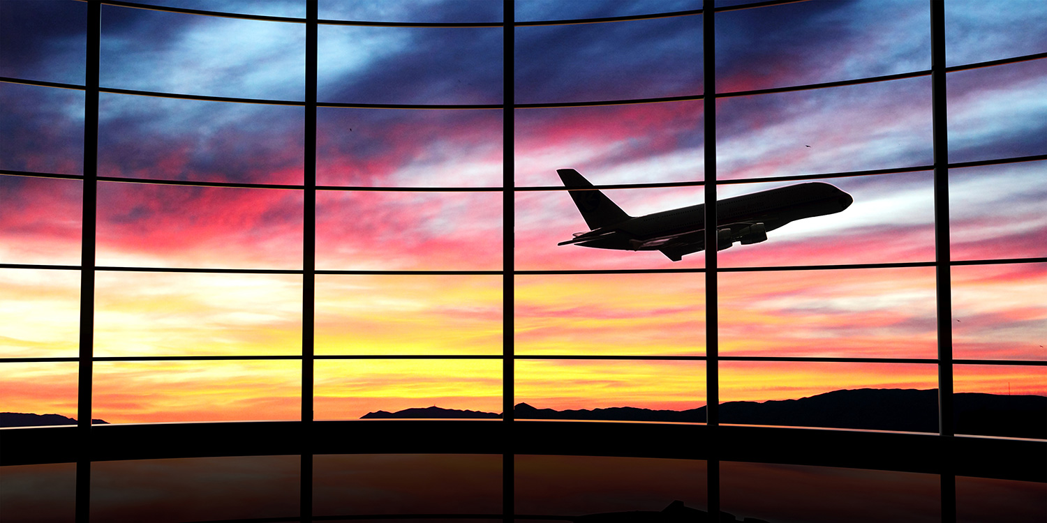 Traveling Naturally: Tips to Keep Your Trip Balanced An airplane taking off under a relaxing sunset
