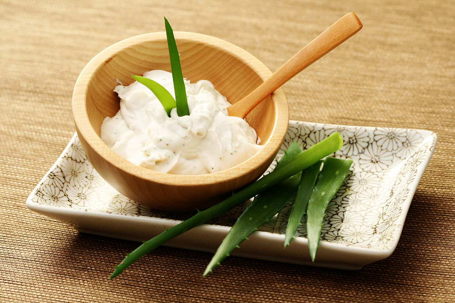 Desert Harvest Aloe Renew a bowl of aloe cream and stems from the aloe vera plant