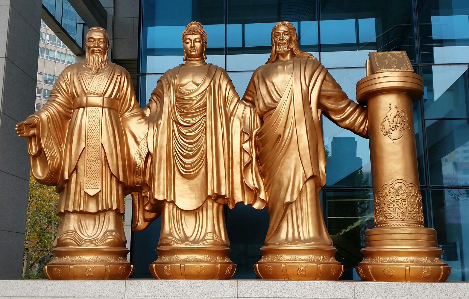 Random Thoughts in a Time of Great Change statues of spiritual leaders in a commercial district