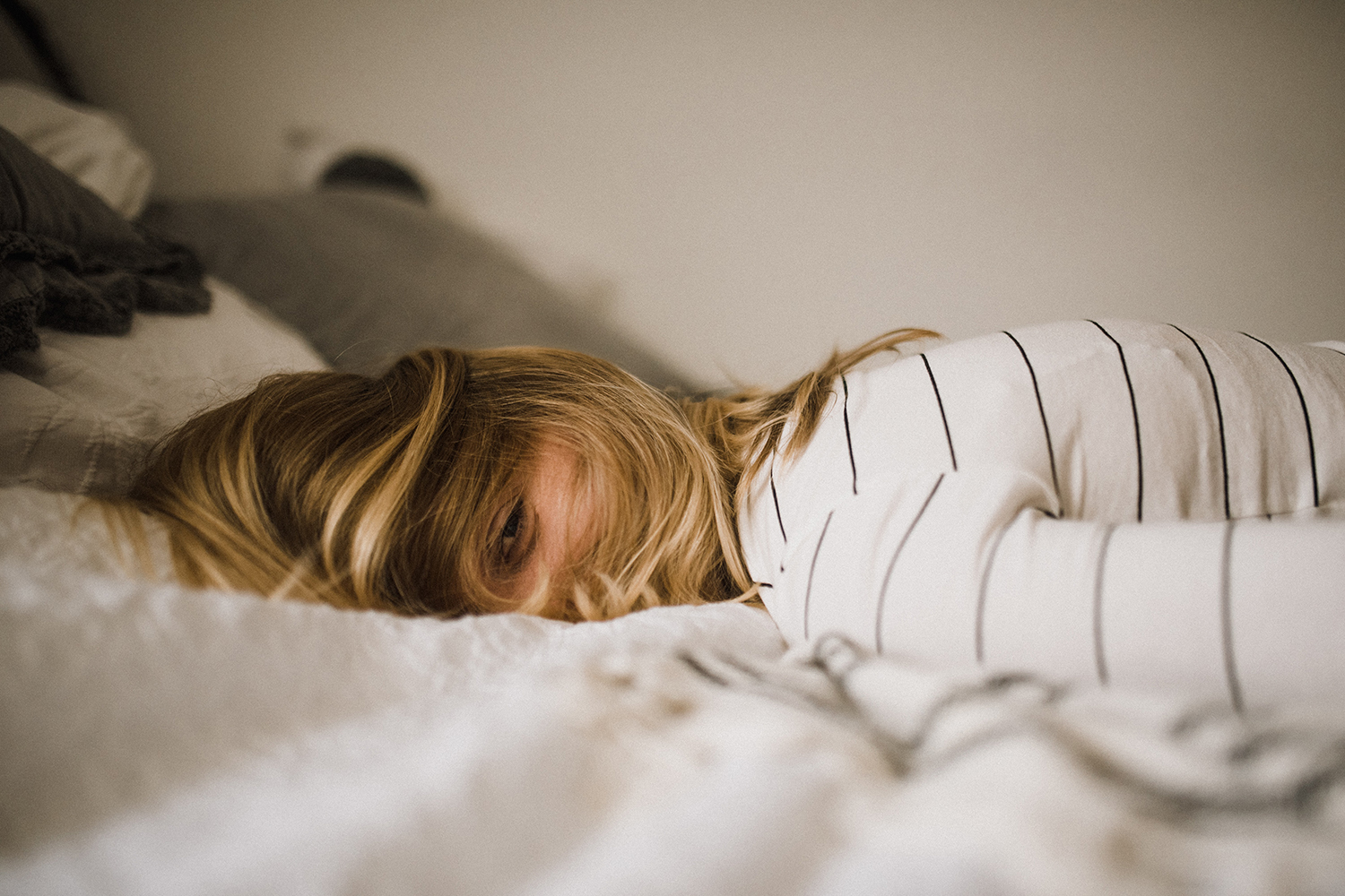 a woman collapsed on a bed from anxiety