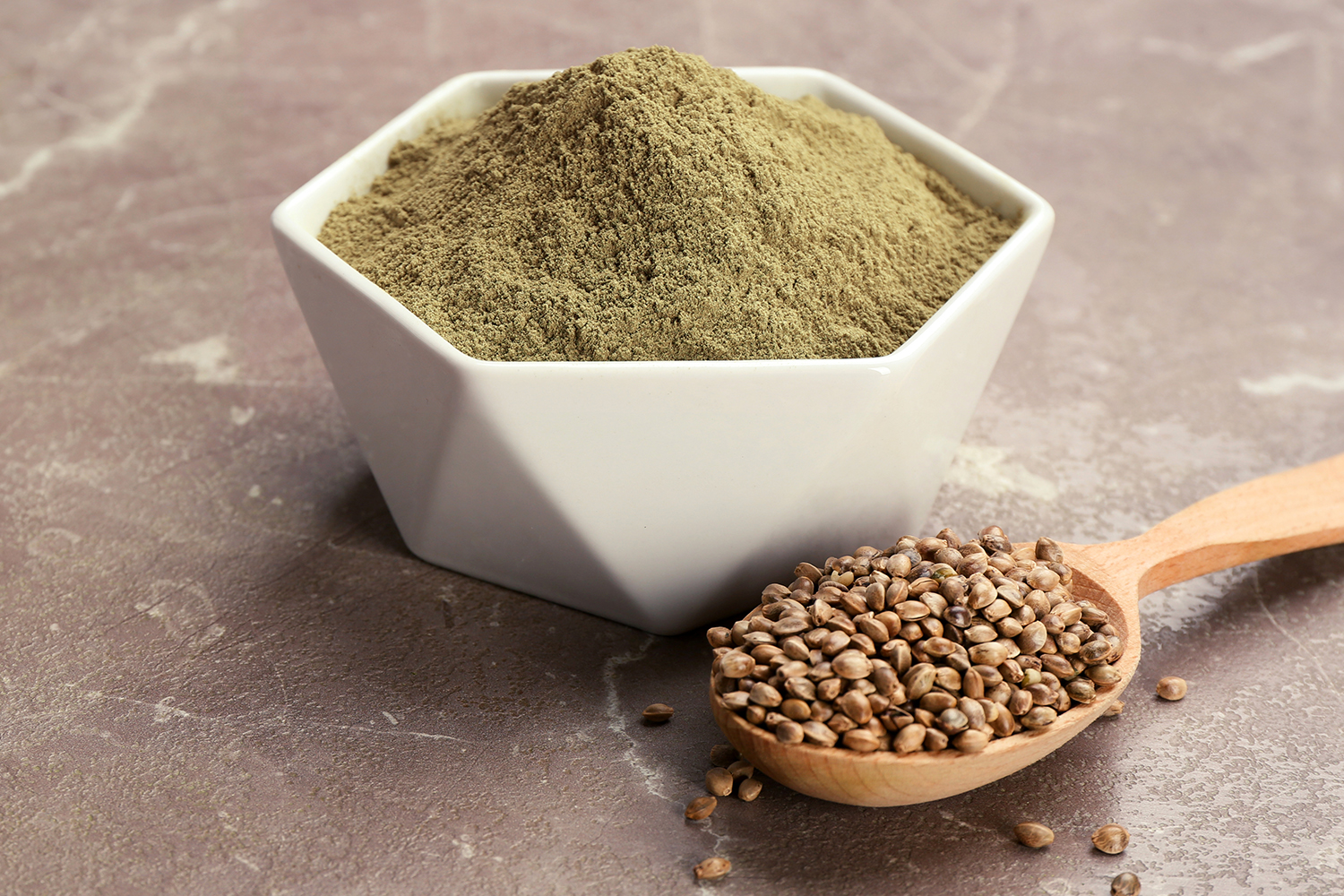 Protein Builds Power with Powder a spoon full of hemp seeds, and a bowl of protein powder