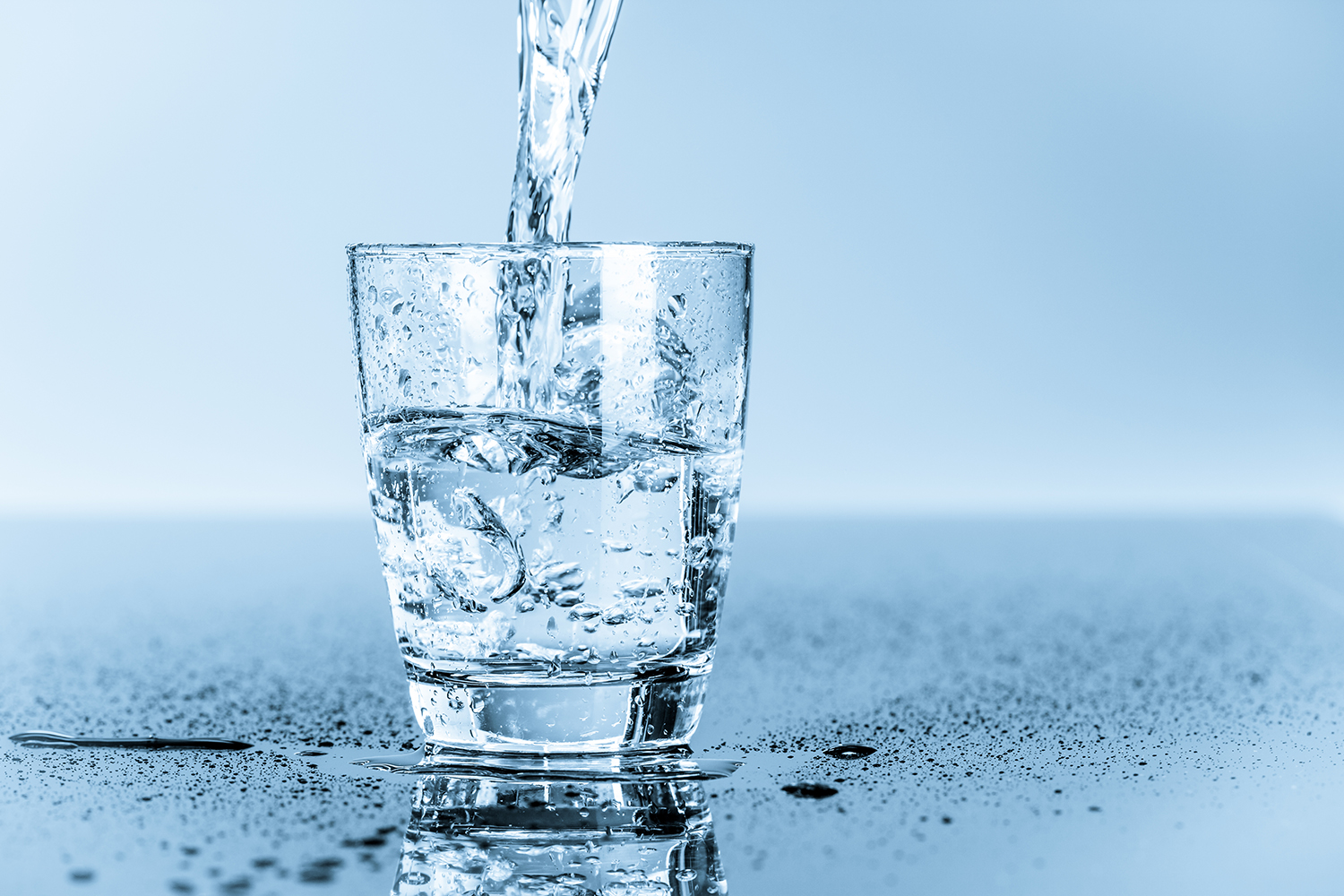 a glass of water being filled