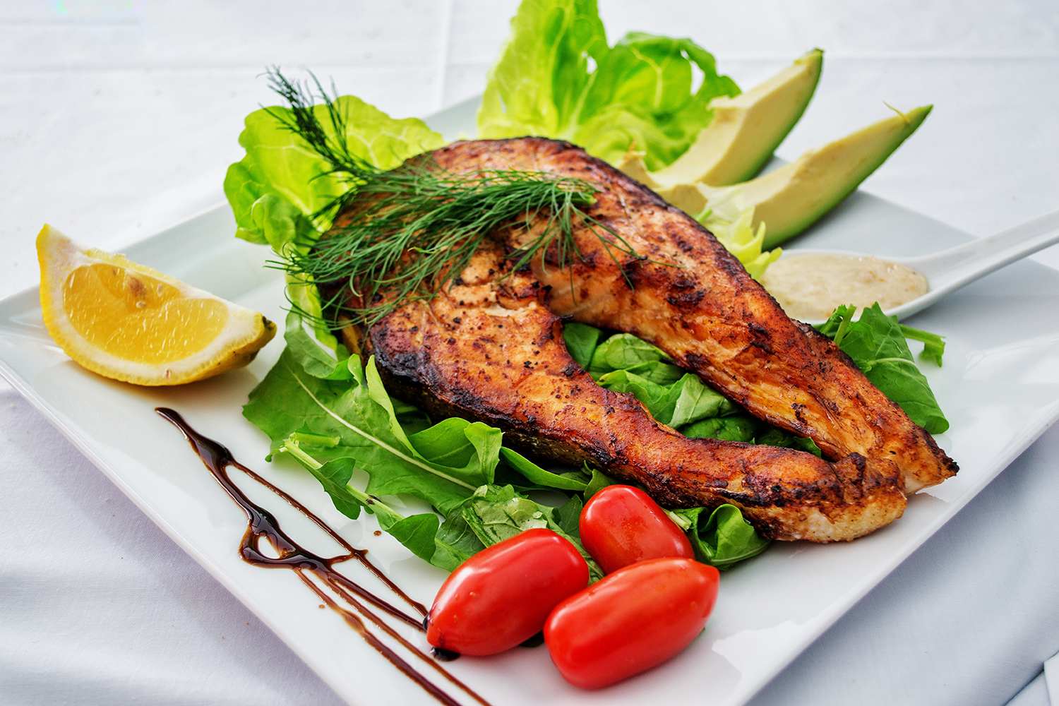 a keto-friendly meal of fish, avocado, and vegetables