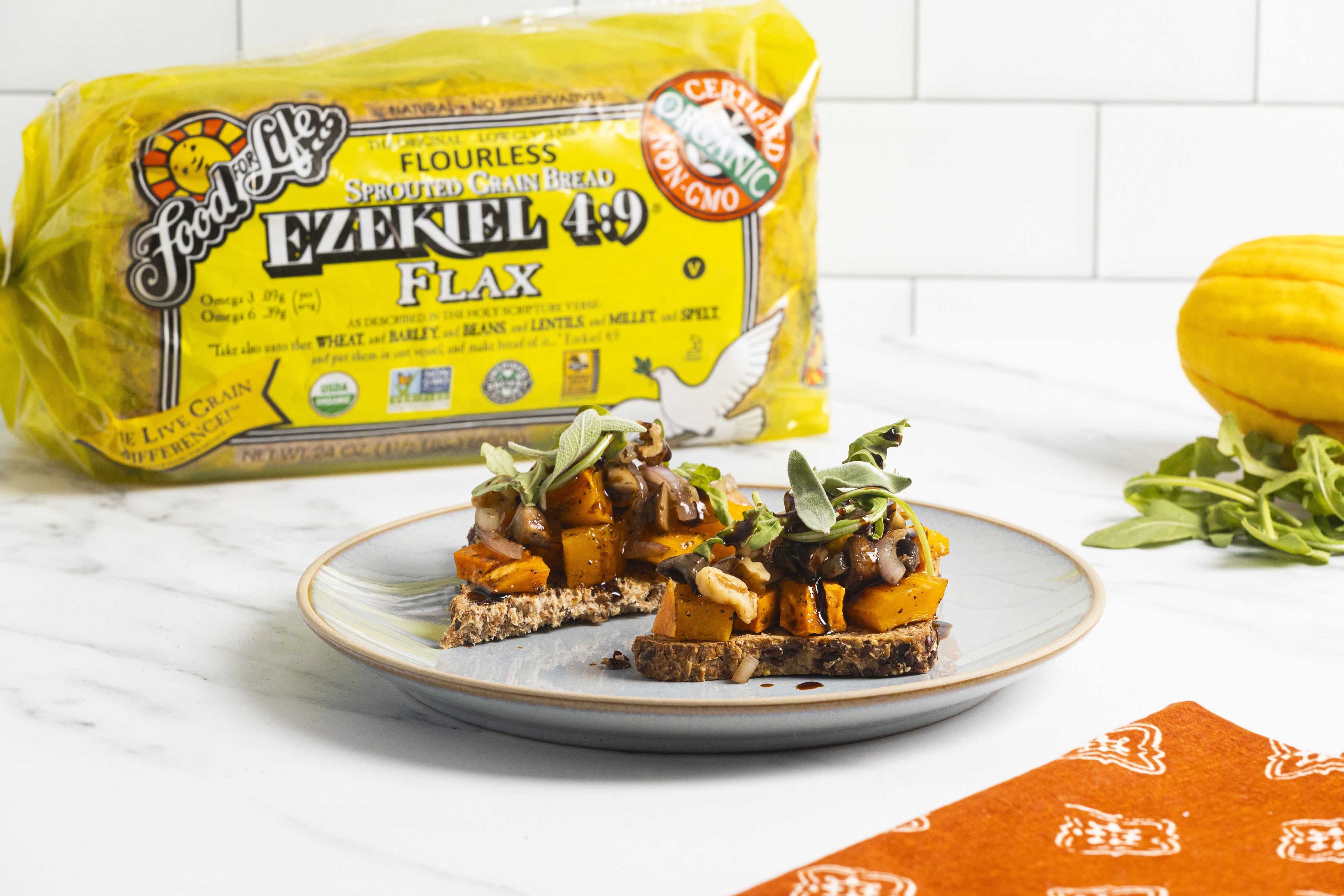 autumn bruschetta on a plate and Food for Life Ezekiel 4:9 Flax bread in the background