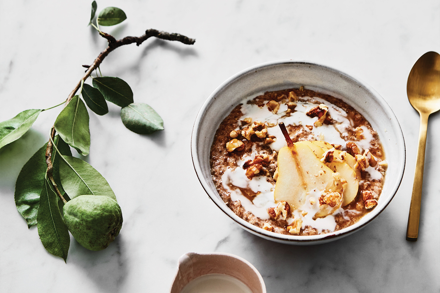 Spiced Pear Porridge a bowl of pear porridge and a dish of honey