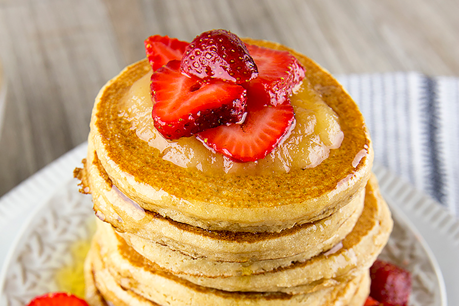 Strawberry Applesauce Pancakes A steaming stack of pancakes with fruit on top