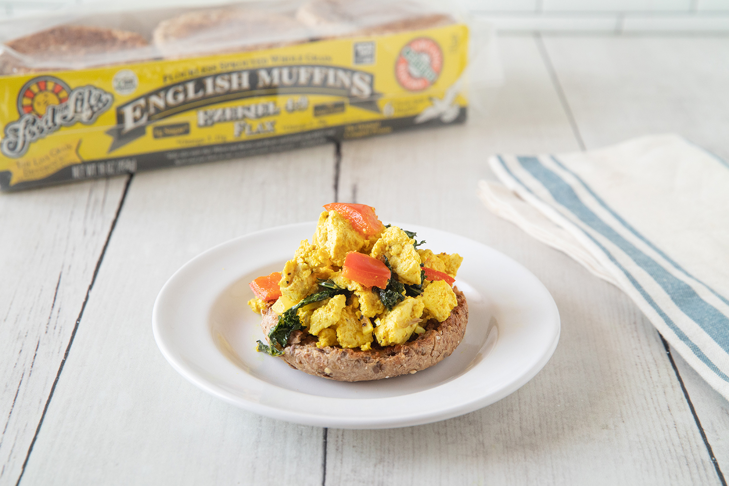 an english muffin topped with tofu scramble