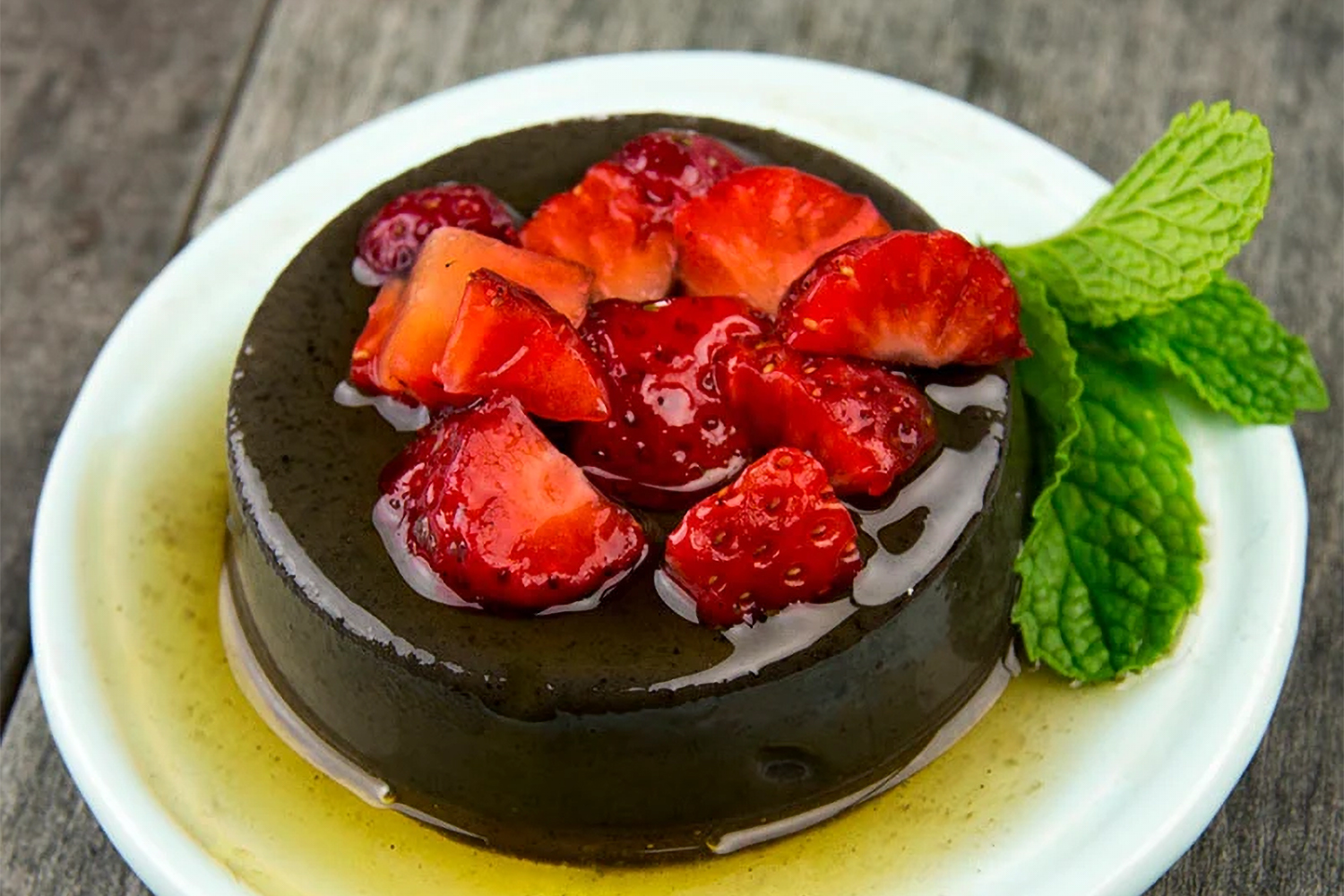 a delicious plate of flan with fruit on top