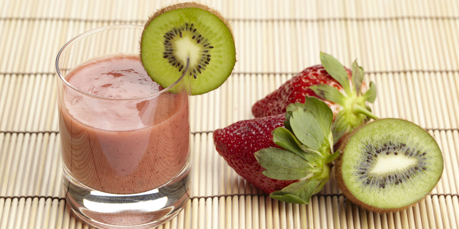 Strawberry Kiwi Smoothie a glass of smoothie next to fresh strawberries and kiwi