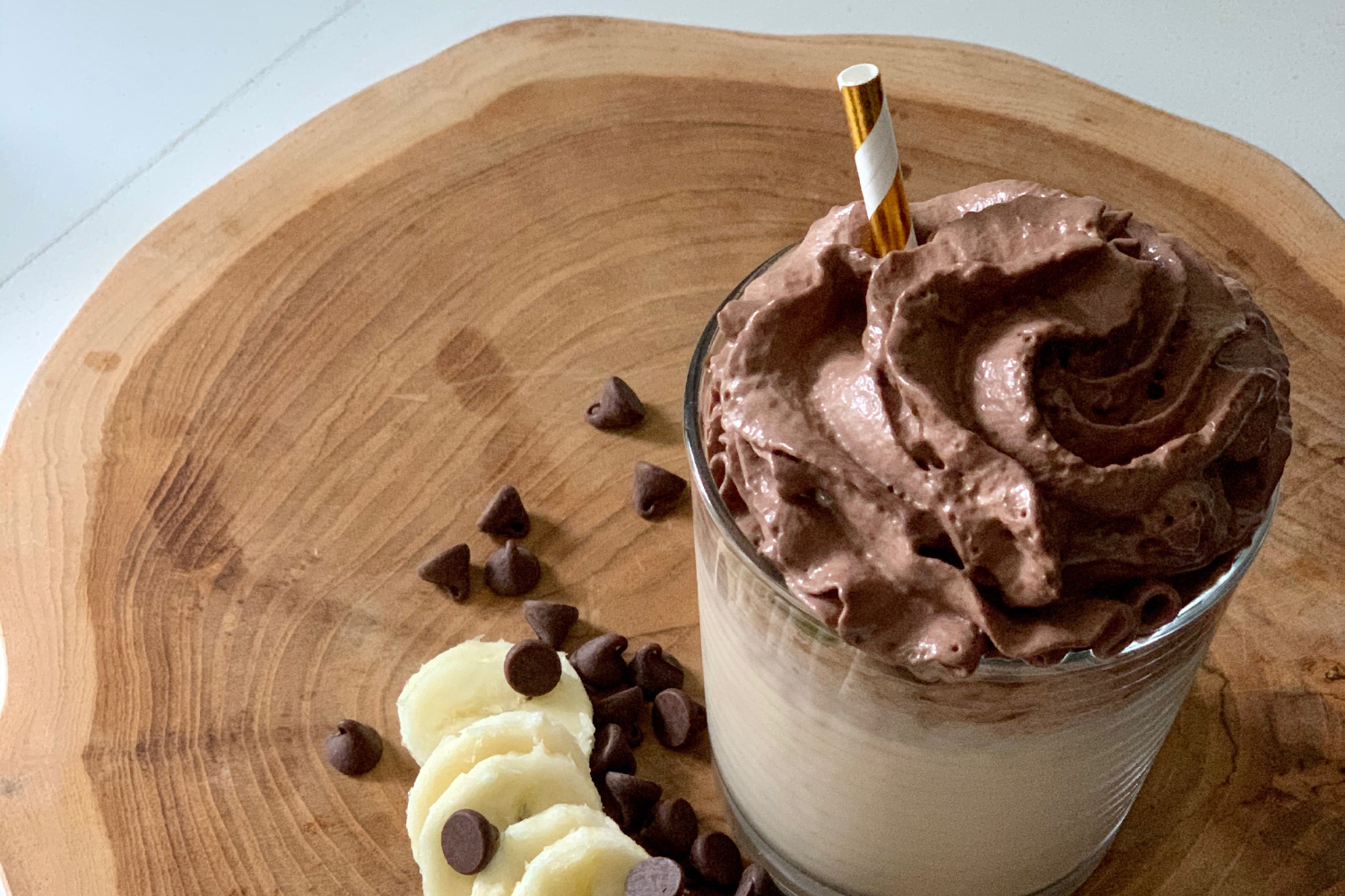 Super Bananutella Smoothie A Bananutella Smoothie on a wooden cutting board ready to enjoy.