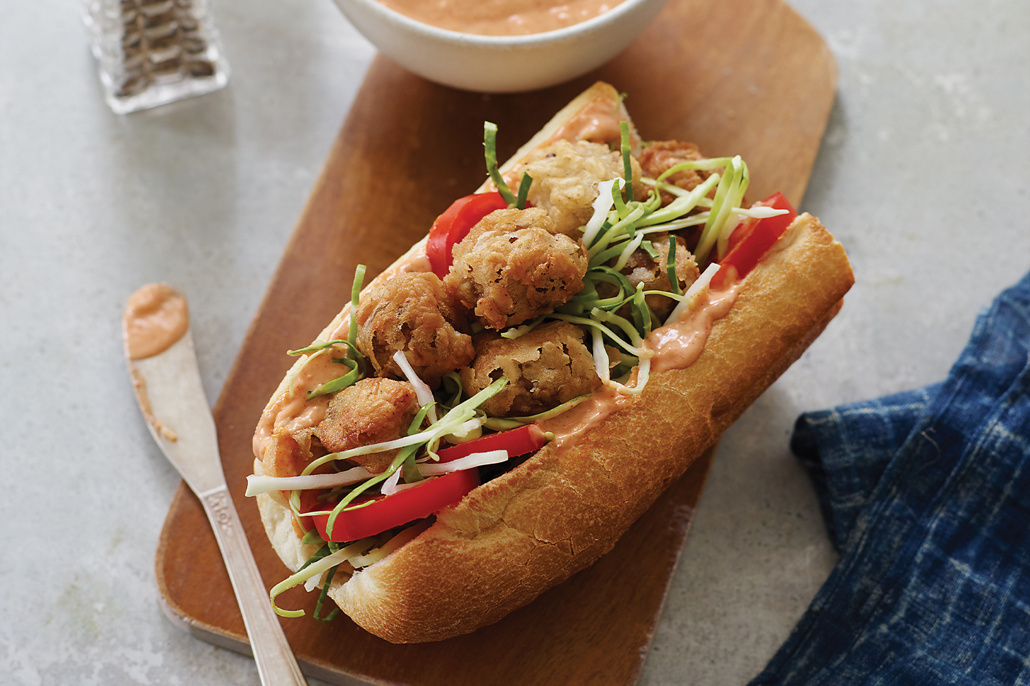 Crispy Mushroom Po’ Boy Sandwiches a sandwich roll filled with breaded mushrooms
