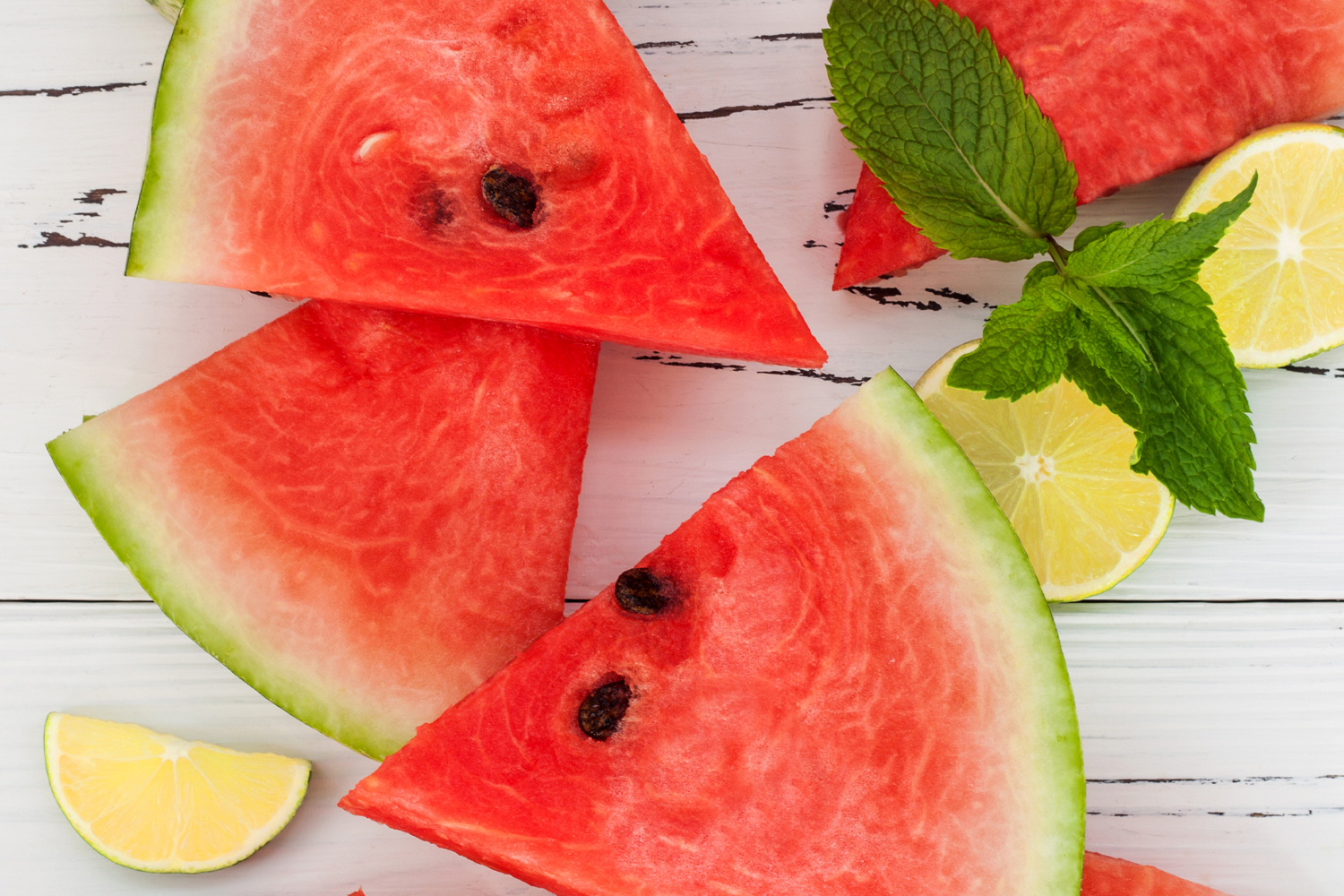Minted Watermelon Salad slices of watermelon and lemon with mint leaves