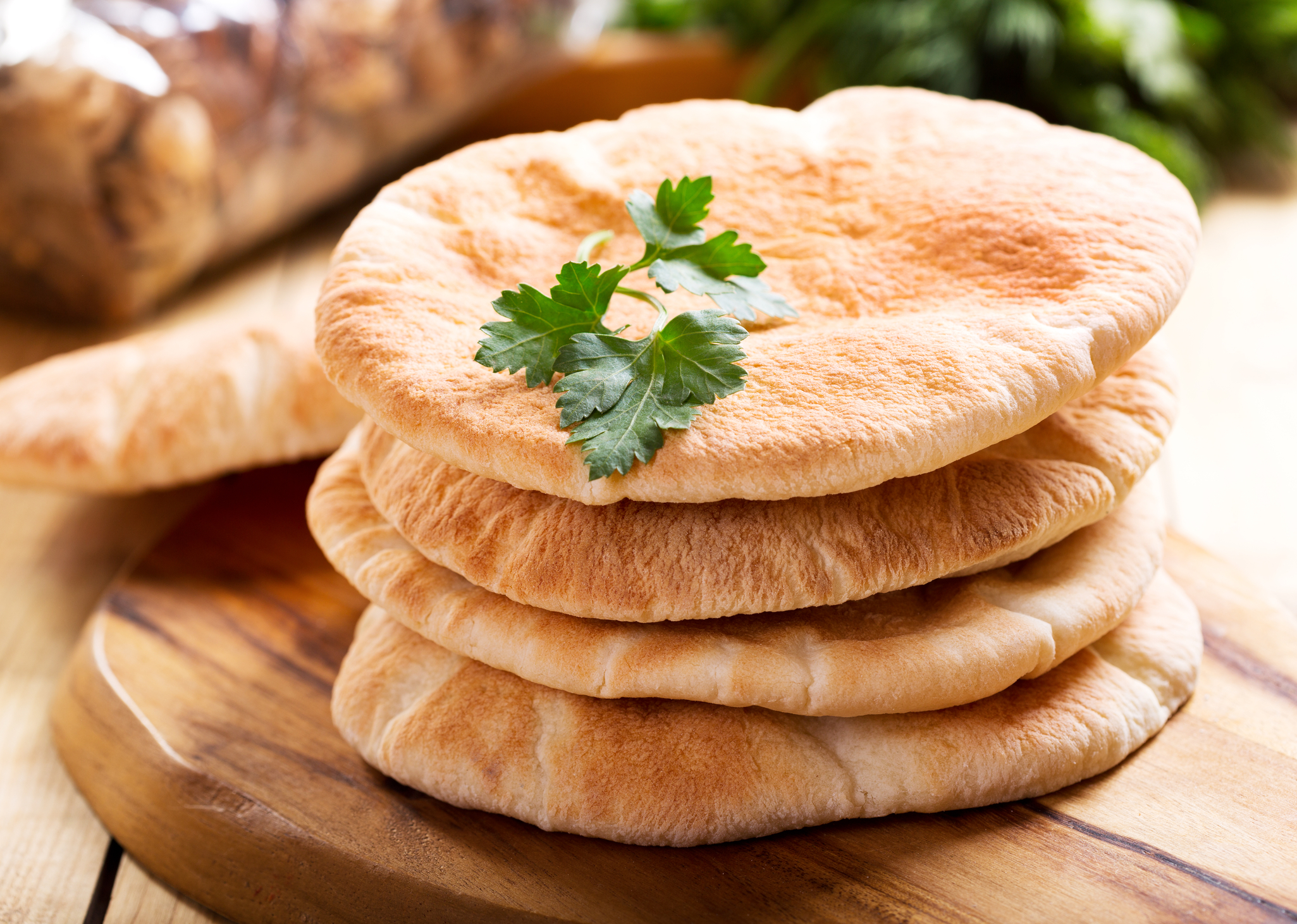 Pita Bread Four pieces of pita bread in a stack.