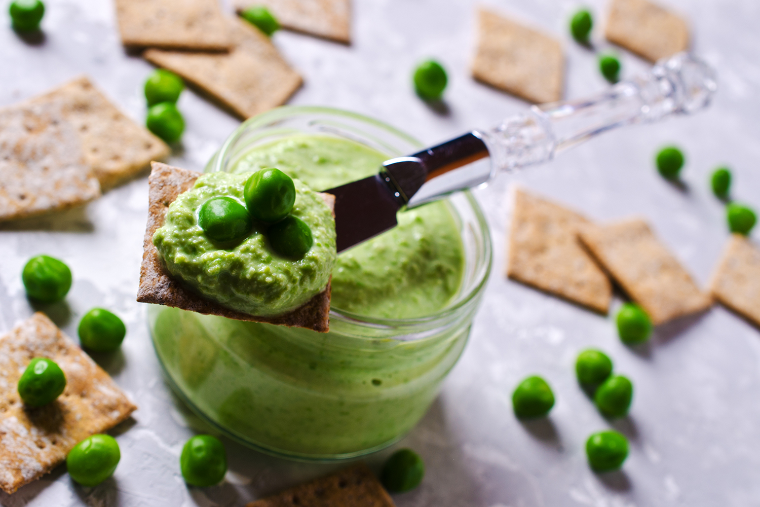 Sweet Pea Dip A jar of sweet green pea dip, with crackers