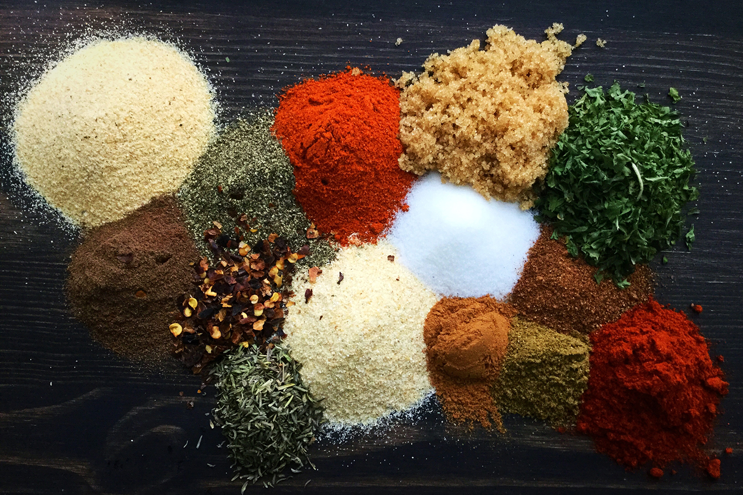 piles of herbs and spices used to make Jamaican jerk seasoning