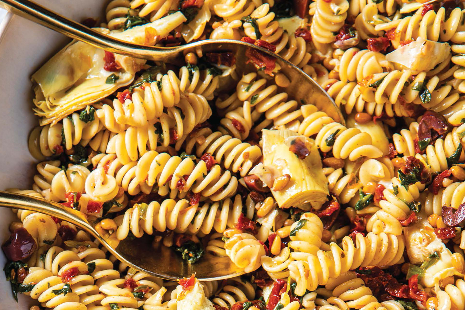 Fusilli Salad a bowl of fusilli with spinach, artichokes, and sun-dried tomatoes