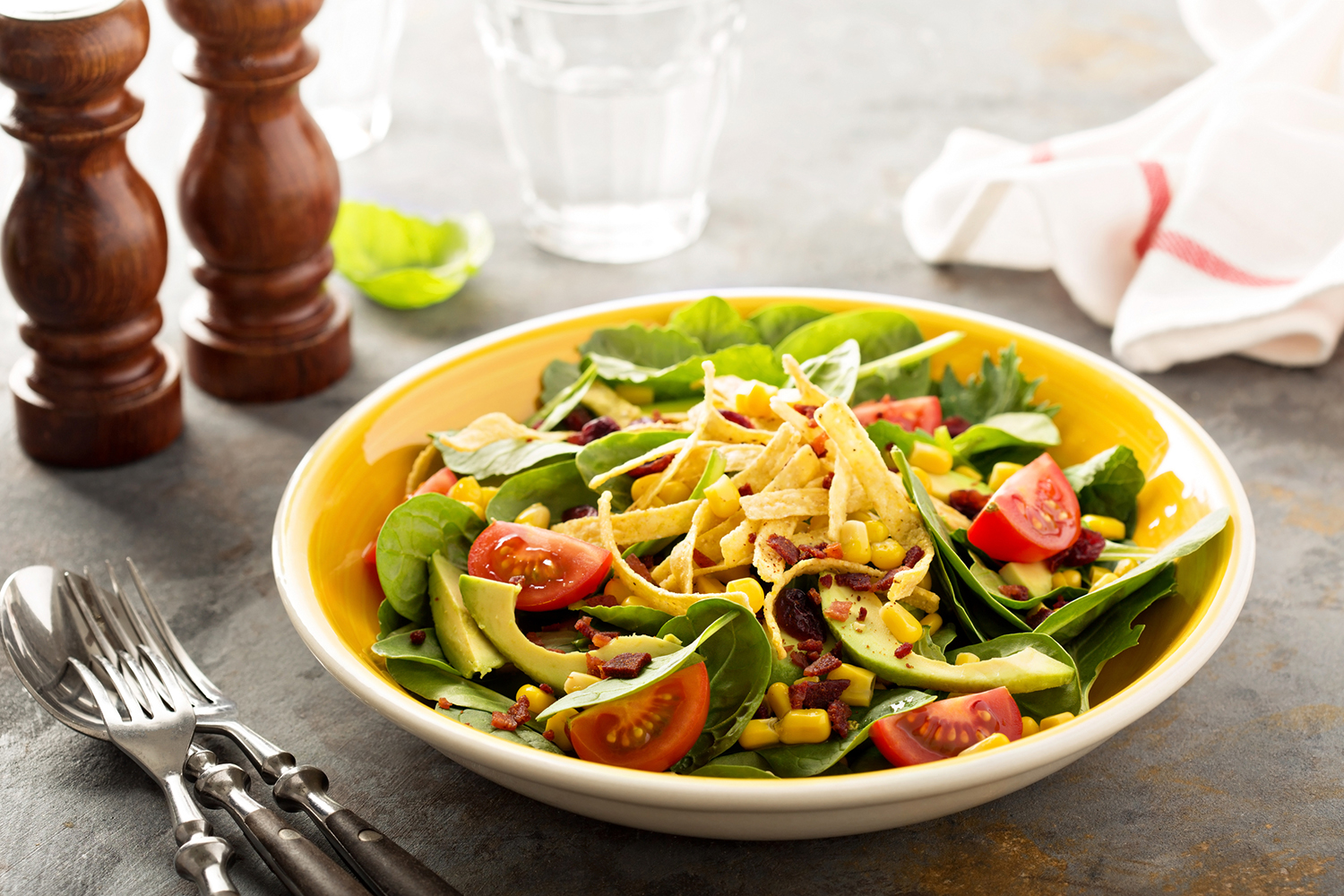a bowl of mexican-inspired salad with corn and avocado
