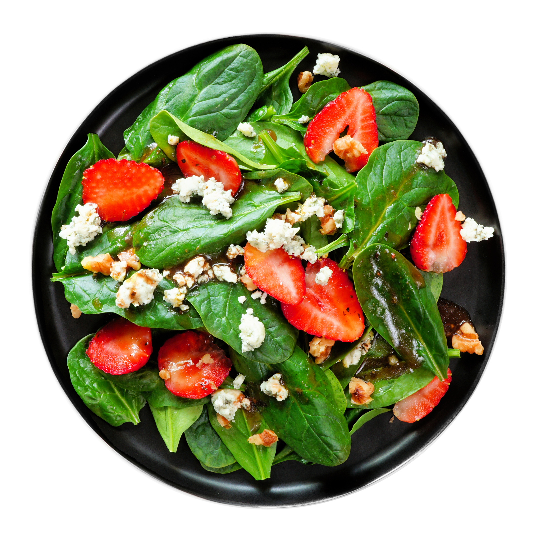 Black salad bowl filled with baby spinach, sliced strawberries, and blue cheese.