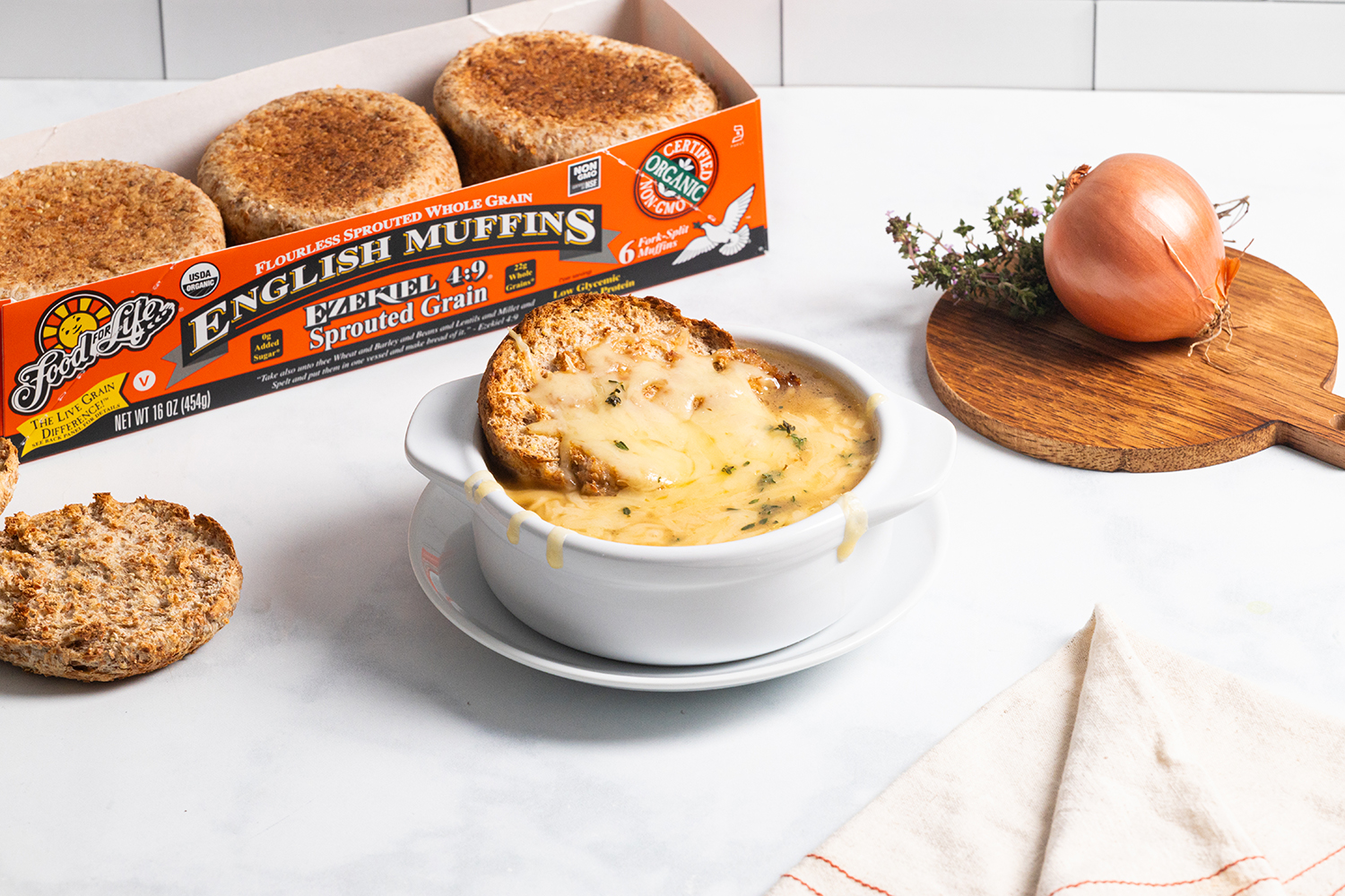 Broiled English Muffin French Onion Soup a bowl of french onion soup with a broiled english muffin dipped into it