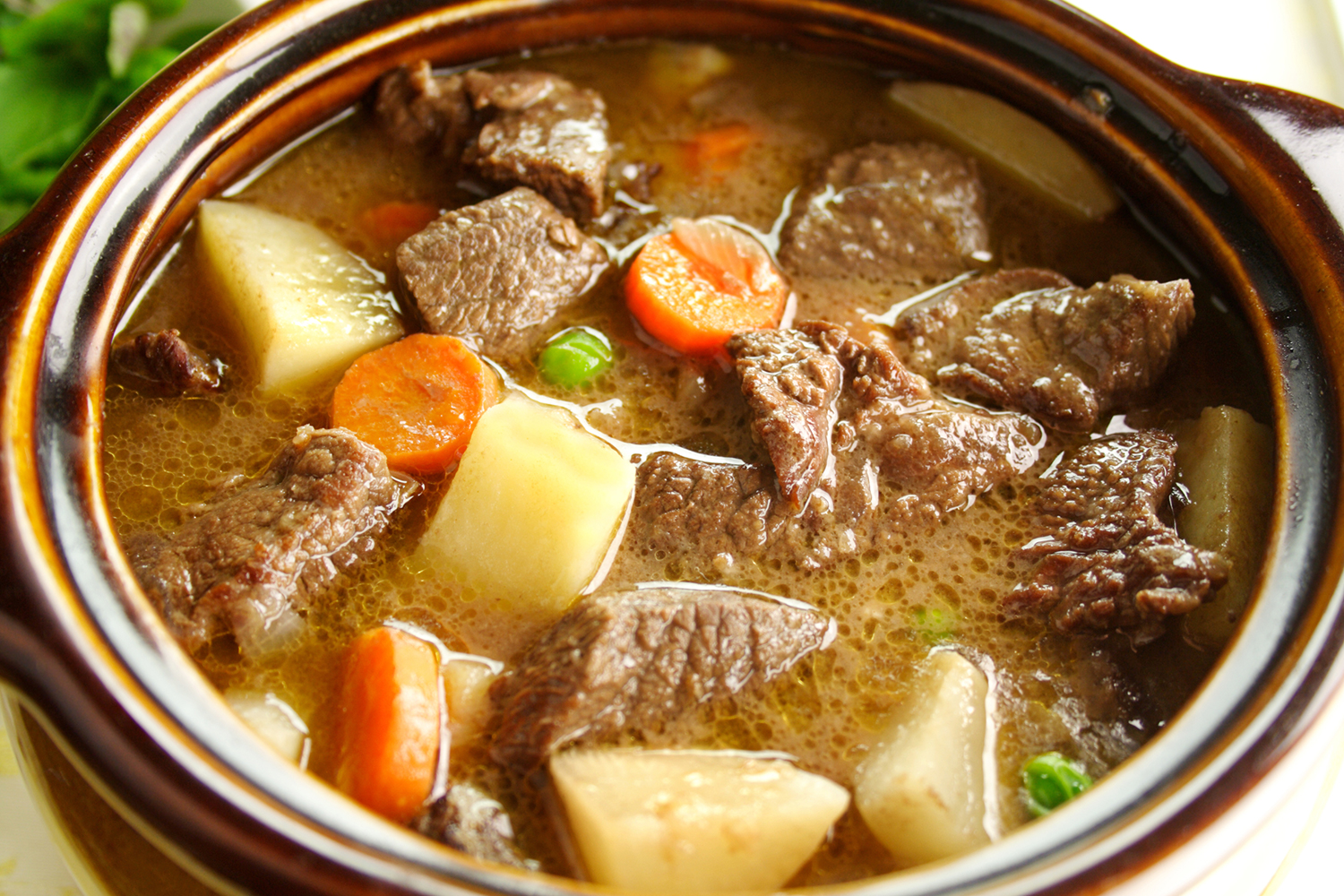 Easy Oven Beef Stew Rich hearty oven beef stew simmering and ready to serve.
