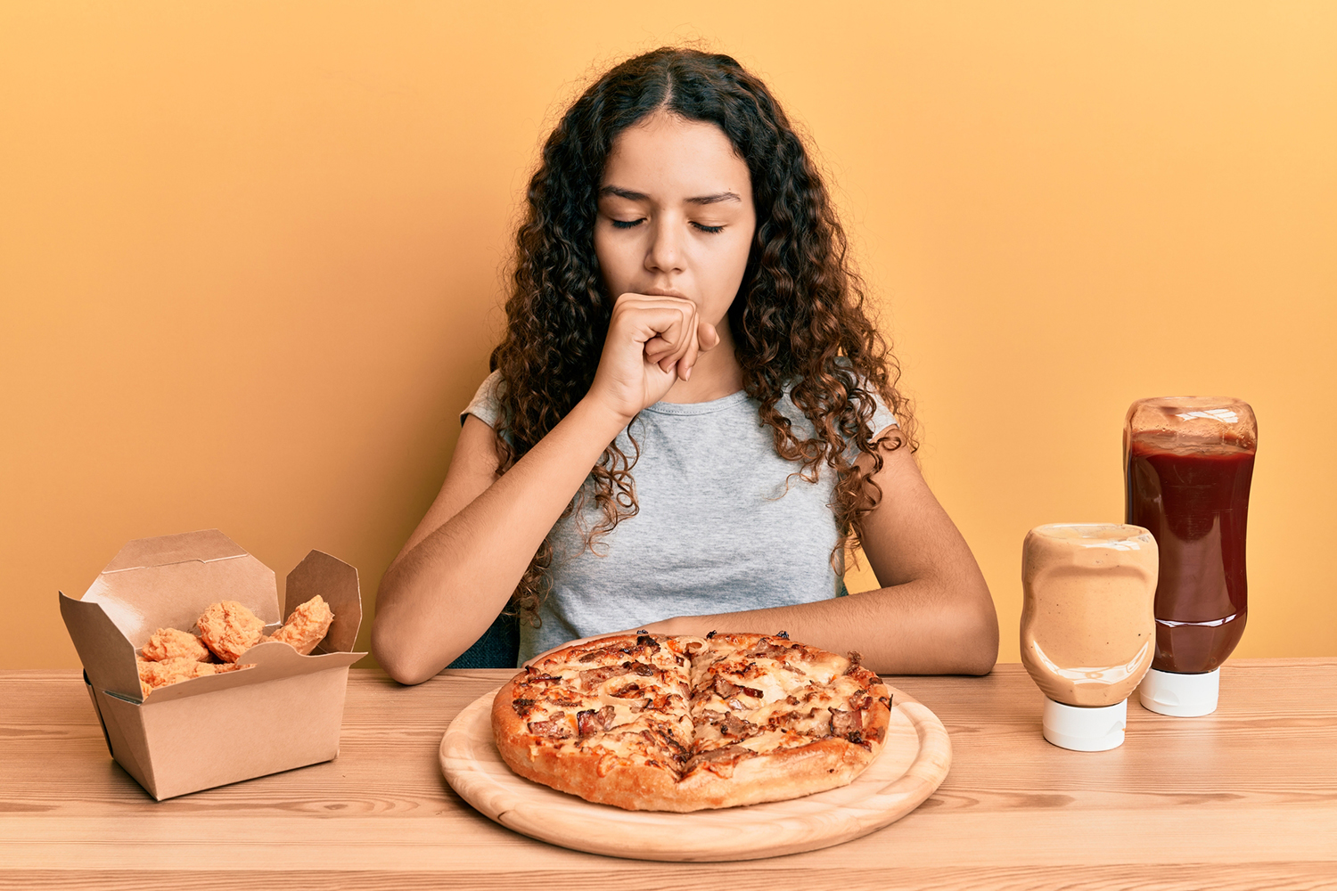 a girl having trouble breathing while eating junk food