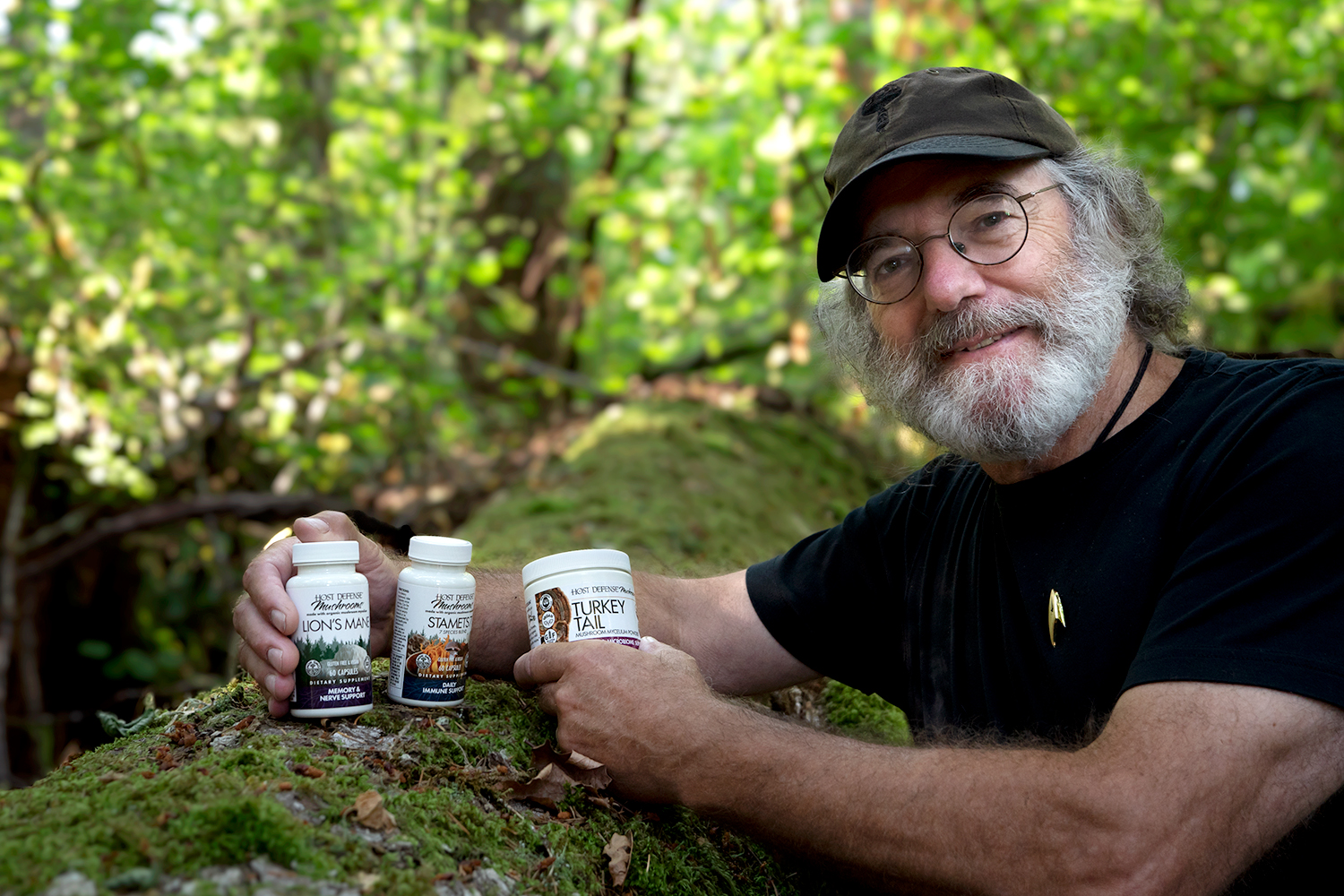 Paul Stamets holding Host Defense packaging