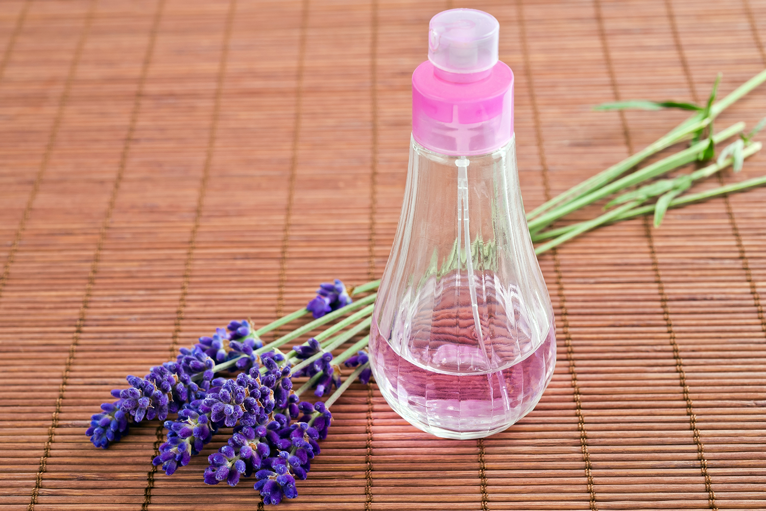 lavender flowers and a spritzer bottle of homemade hydrosol