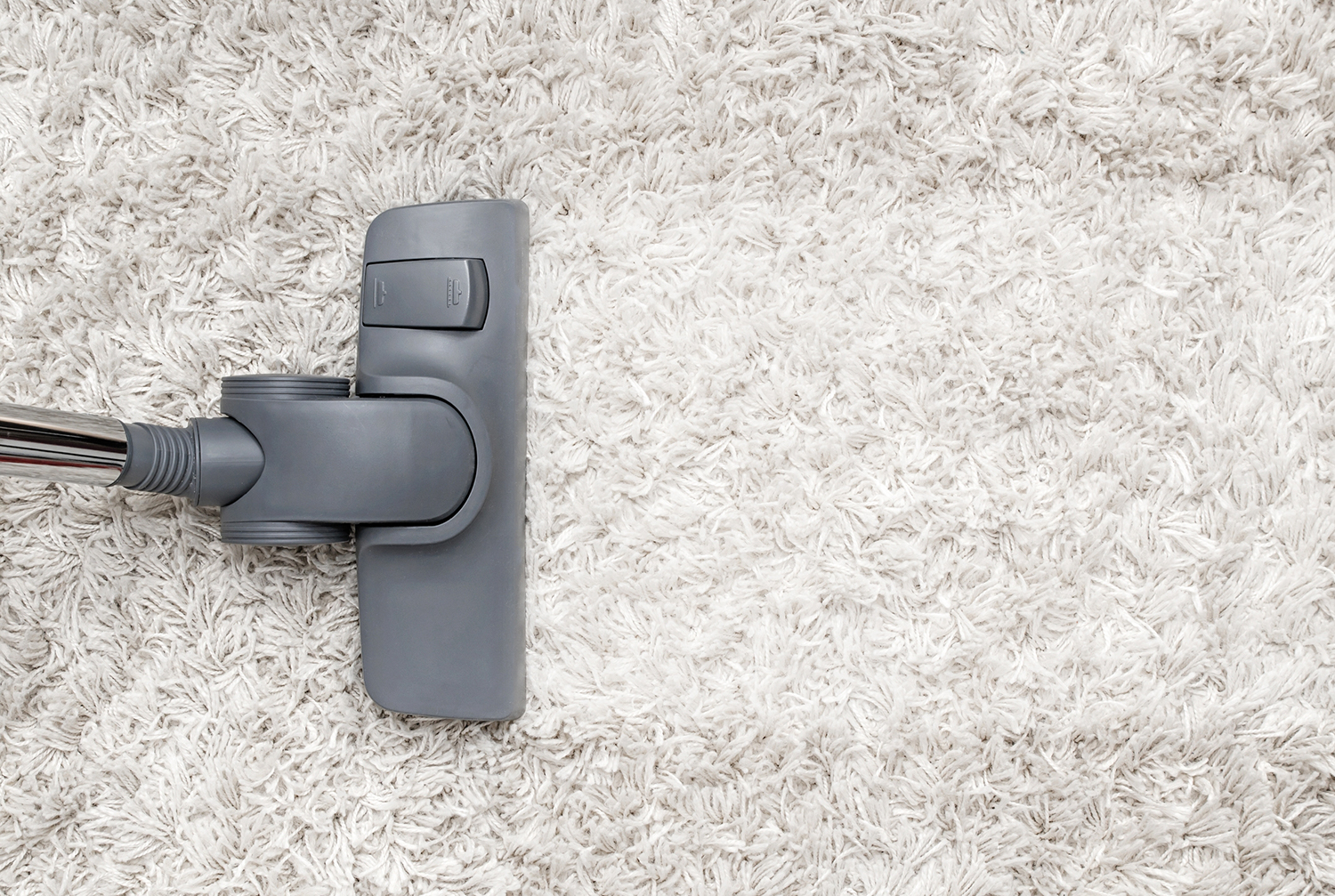 Vacuum on white shag carpet.