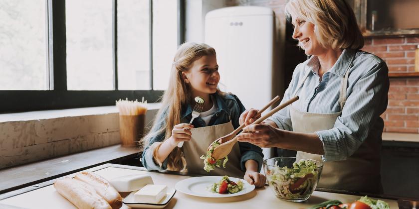 a woman in the kitchen with her granddaughter