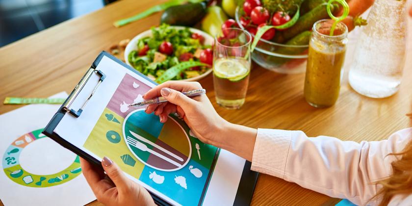 a woman planning her healthy meals and lifestyle goals