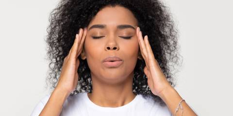 a woman taking deep, calming breaths in a stressful situation
