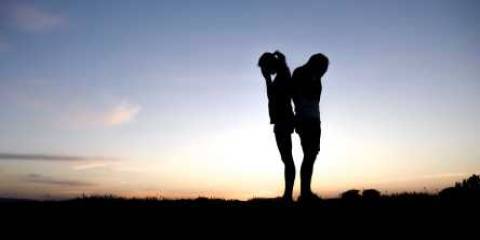 A Couple's silhouette at sunset, breaking up of a relationship. 