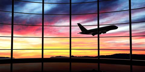 An airplane taking off under a relaxing sunset