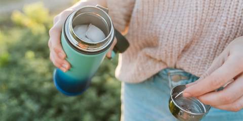 a woman detaching a strainer from her bottle