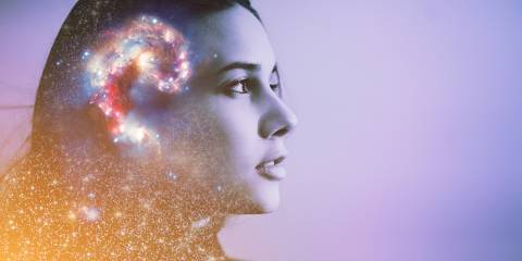 a peaceful woman with a galaxy and cosmos in her mind