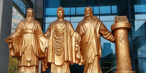 statues of spiritual leaders in a commercial district