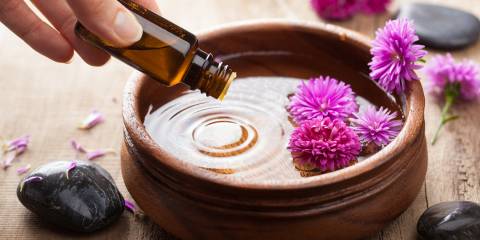 Aromatherapy Essentials: 4 Facts That May Surprise You Essential oil being dripped in to a wooden dish for aromatherapy.