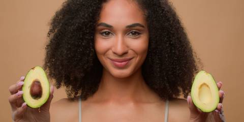 Ayurvedic Beauty a woman with beautiful skin holding avocados