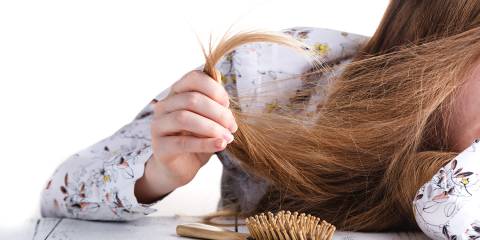 Care for Your Hair a young woman struggling with tangled hair and split ends