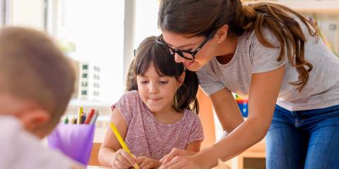 Smart Tips for Healthy Brains a girl getting help from her teacher in class